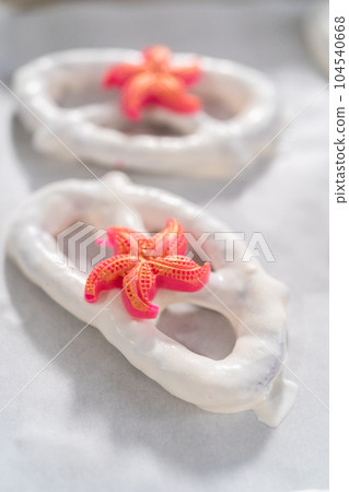 Gourmet chocolate-covered pretzel twists with seashell-shaped chocolates. Gourmet chocolate-covered pretzel twists with seashell-shaped chocolates. 104540668