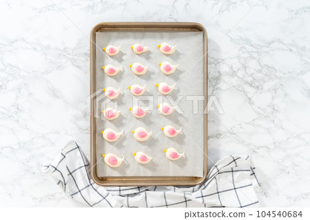 Freshly baked Easter meringue cookies in the shape of birds. Freshly baked Easter meringue cookies in the shape of birds. 104540684