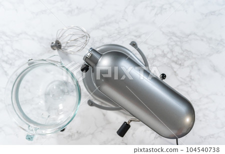 Mixing ingredients in kitchen mixer to bake Easter meringue cookies. Mixing ingredients in kitchen mixer to bake Easter meringue cookies. 104540738