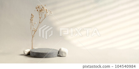 Minimal stone stage product display with sunlight from window and dry flower on cream color background 104540984