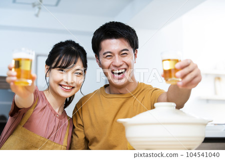 Young couple toasting with beer 104541040