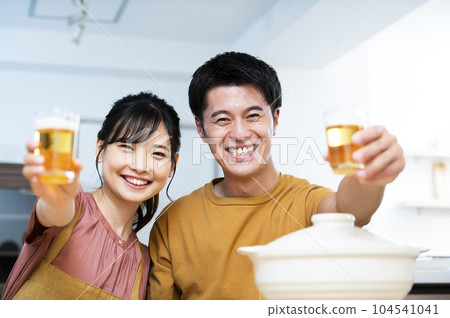 Young couple toasting with beer Young couple toasting with beer 104541041