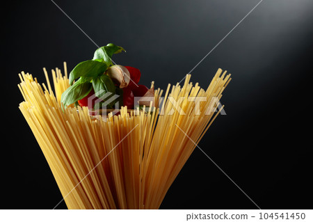 Raw spaghetti with tomato, garlic, and basil. 104541450