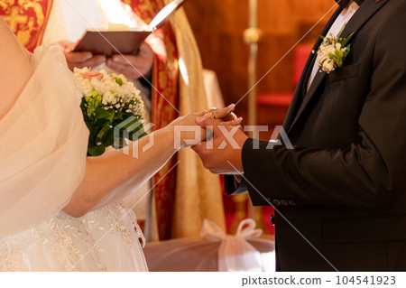 Catholic wedding church man puts ring woman after blessing Catholic wedding betrothal 104541923