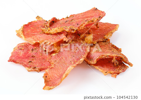 Dried pork jerky slices isolated 104542130