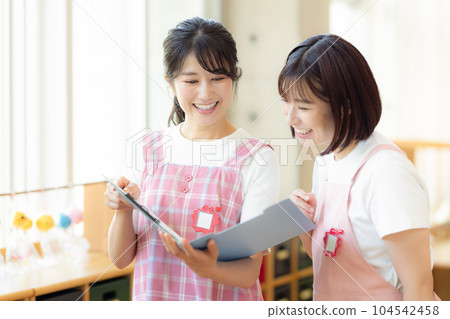Nursery teacher having a meeting Nursery teacher having a meeting 104542458