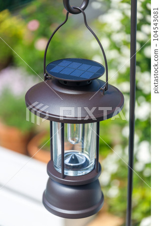 Charging a solar lantern with sunlight Charging a solar lantern with sunlight 104543081