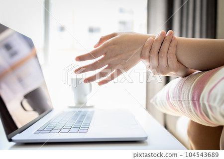 Female office worker suffering from Carpal Tunnel Syndrome,painful and numbness in hands,pain of typing on keyboard for long time,inflammation of tendon,wrist injury,office syndrome,healthcare concept 104543689