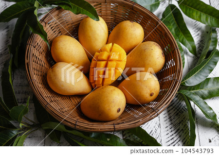 yellow ripe mangoes in basket 104543793