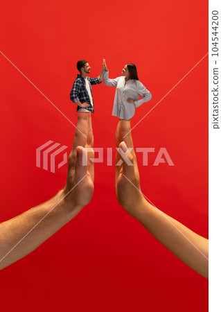 Creative collage with hands. Young man and woman giving high five with hands symbolizing support, partnership, agreement and cooperation. Creative collage with hands. Young man and woman giving high five with hands symbolizing support, partnership, agreement and cooperation. 104544200