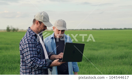 businessman farmer working field with laptop. partnership work. business partners talking about deal. agricultural industry farmer, digital computer, business transaction, conversation farmer field 104544617