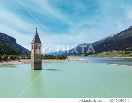 The bell tower in Reschensee and family (Italy). 104544634