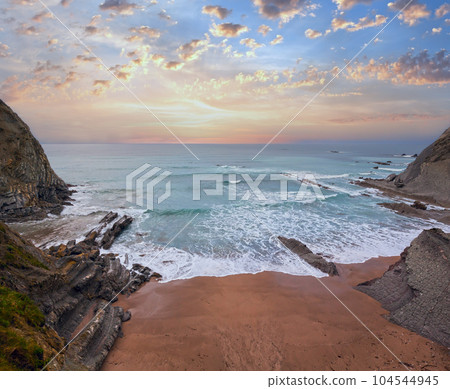 Evening ocean rocky coast. 104544945