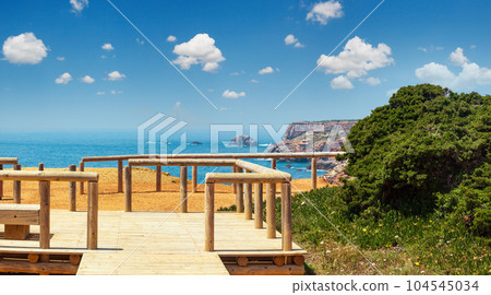 Wooden paths and observation decks on summer Atlantic rocky coast Wooden paths and observation decks on summer Atlantic rocky coast 104545034