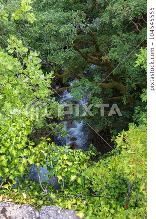 Summer mountains countryside view from Elenski Skok ancient small pedestrian stone bridge above stream in deep gorge. North Macedonia not far from Debar Town, Europe. 104545555