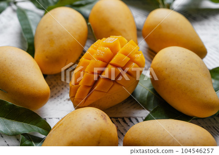 Ripe mangoes on white wood 104546257