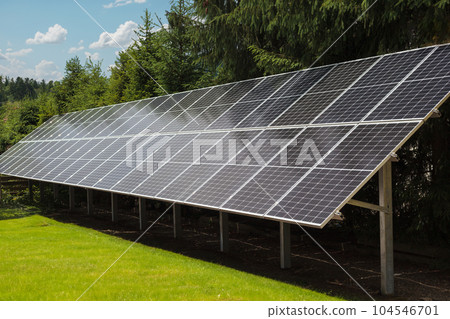 Solar panels against the background of greenery, nature. Clean energy concept. Solar panels against the background of greenery, nature. Clean energy concept. 104546701