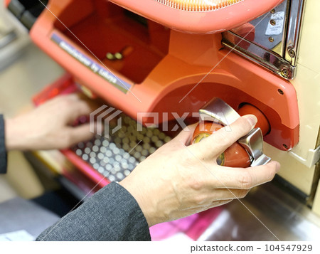 Hand up of a woman playing pachinko 104547929