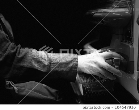 Woman's hand hitting pachinko _ monochrome Woman's hand hitting pachinko _ monochrome 104547930