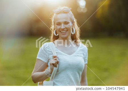 Portrait of smiling modern 40 years old woman in white shirt Portrait of smiling modern 40 years old woman in white shirt 104547941