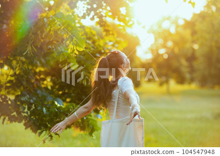 smiling modern woman in white shirt outdoors smiling modern woman in white shirt outdoors 104547948