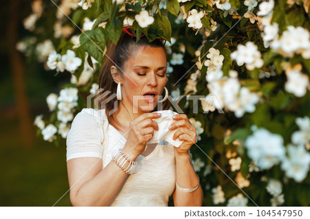 sad stylish female in white shirt has allergy attack and sad stylish female in white shirt has allergy attack and 104547950