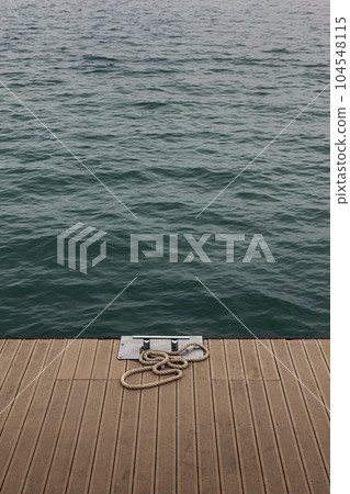 Mooring bollard and blue sea 104548115