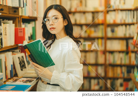 young woman in a bookstore 104548544
