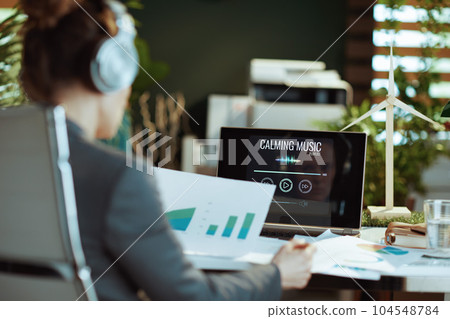 Seen from behind woman listening to music 104548784