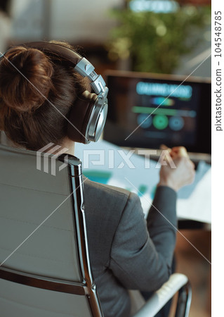 Seen from behind business woman listening to music 104548785