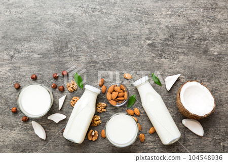Set or collection of various vegan milk almond, coconut, cashew, on table background. Vegan plant based milk and ingredients, top view Set or collection of various vegan milk almond, coconut, cashew, on table background. Vegan plant based milk and ingredients, top view 104548936