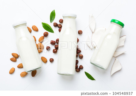 Set or collection of various vegan milk almond, coconut, cashew, on table background. Vegan plant based milk and ingredients, top view Set or collection of various vegan milk almond, coconut, cashew, on table background. Vegan plant based milk and ingredients, top view 104548937