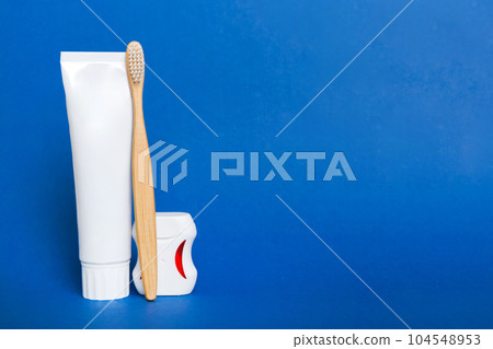 toothpaste and toothbrush top view with copy space on colored background. Flat lay. Dental hygiene. Oral care products on light background. Body care concept toothpaste and toothbrush top view with copy space on colored background. Flat lay. Dental hygiene. Oral care products on light background. Body care concept 104548953
