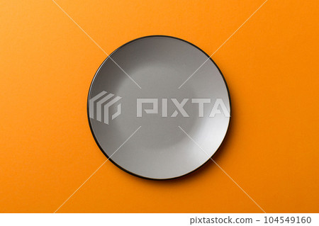 Top view of isolated of colored background empty round gray plate for food. Empty dish with space for your design 104549160