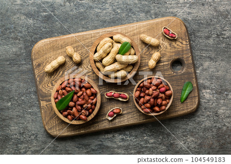 Fresh healthy peanuts in bowl on colored table background. Top view Healthy eating bertholletia concept. Super foods Fresh healthy peanuts in bowl on colored table background. Top view Healthy eating bertholletia concept. Super foods 104549183