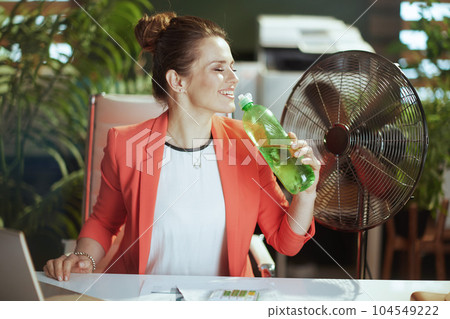 happy modern business woman at work in red jacket 104549222