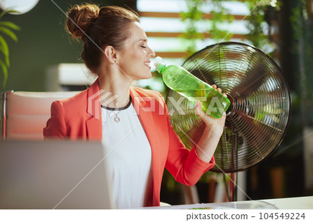 happy modern female employee at work in red jacket 104549224