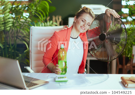 happy modern small business owner woman at work in red jacket 104549225