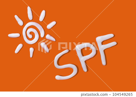 SPF cream. Sunscreen cream in a sun shape on orange background. Creative idea of suntan lotion cream. Sun ultraviolet protection concept. SPF cream. Sunscreen cream in a sun shape on orange background. Creative idea of suntan lotion cream. Sun ultraviolet protection concept. 104549265