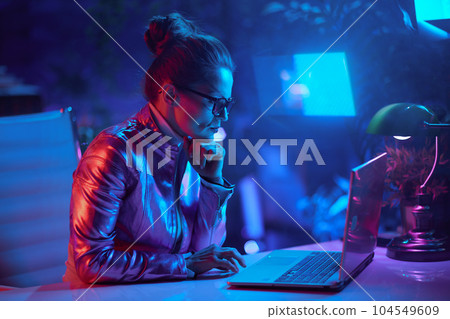 elegant woman in glasses using laptop and using video chat 104549609