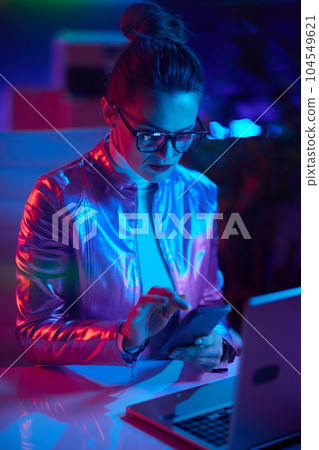 pensive trendy business woman in glasses with laptop 104549621
