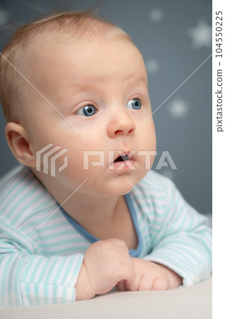 Cute newborn baby with blue eyes - closeup portrait. Little boy looking away. Cute newborn baby with blue eyes - closeup portrait. Little boy looking away. 104550225