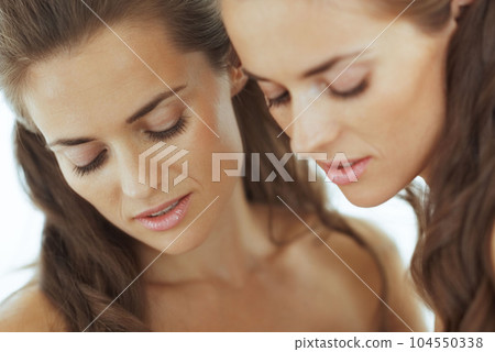 young woman with reflection in mirror young woman with reflection in mirror 104550338