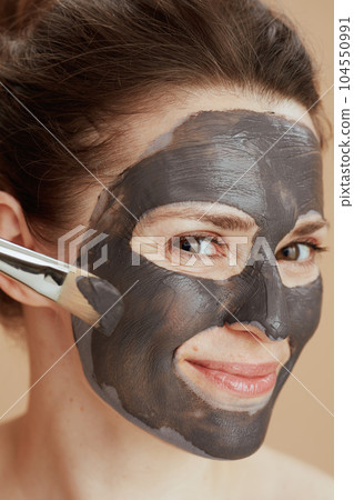 happy modern female with brush and cosmetic mask 104550991