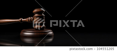 Wooden court gavel on a black background with empty space for insertion. 104551205