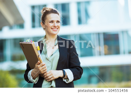 happy modern 40 years old business woman in business district 104551456