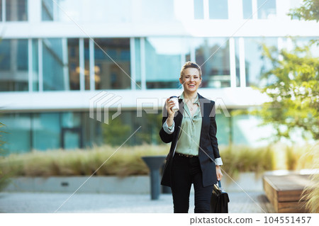happy modern woman worker in business district walking 104551457