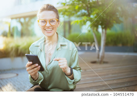 happy modern business woman in green blouse and eyeglasses happy modern business woman in green blouse and eyeglasses 104551470