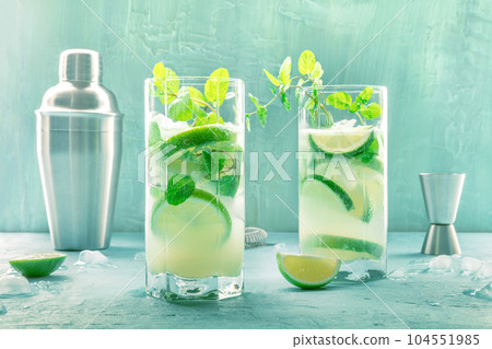 Mojito cocktail. Summer cold drink with lime, fresh mint, and ice. Cool beverage Mojito cocktail. Summer cold drink with lime, fresh mint, and ice. Cool beverage 104551985