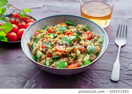 Quinoa tabbouleh salad in a bowl, a healthy dinner with tomatoes and mint Quinoa tabbouleh salad in a bowl, a healthy dinner with tomatoes and mint 104551993